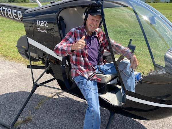 a person sitting on a helicopter