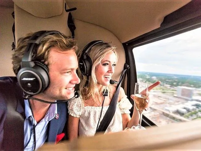 a couple enjoying the view from inside a helicopter